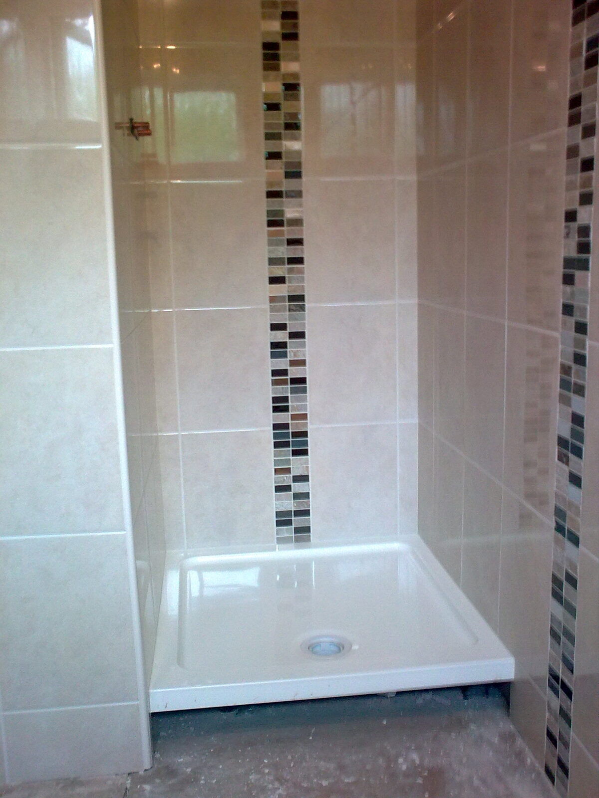 Tiled bathroom wall with mosaic border