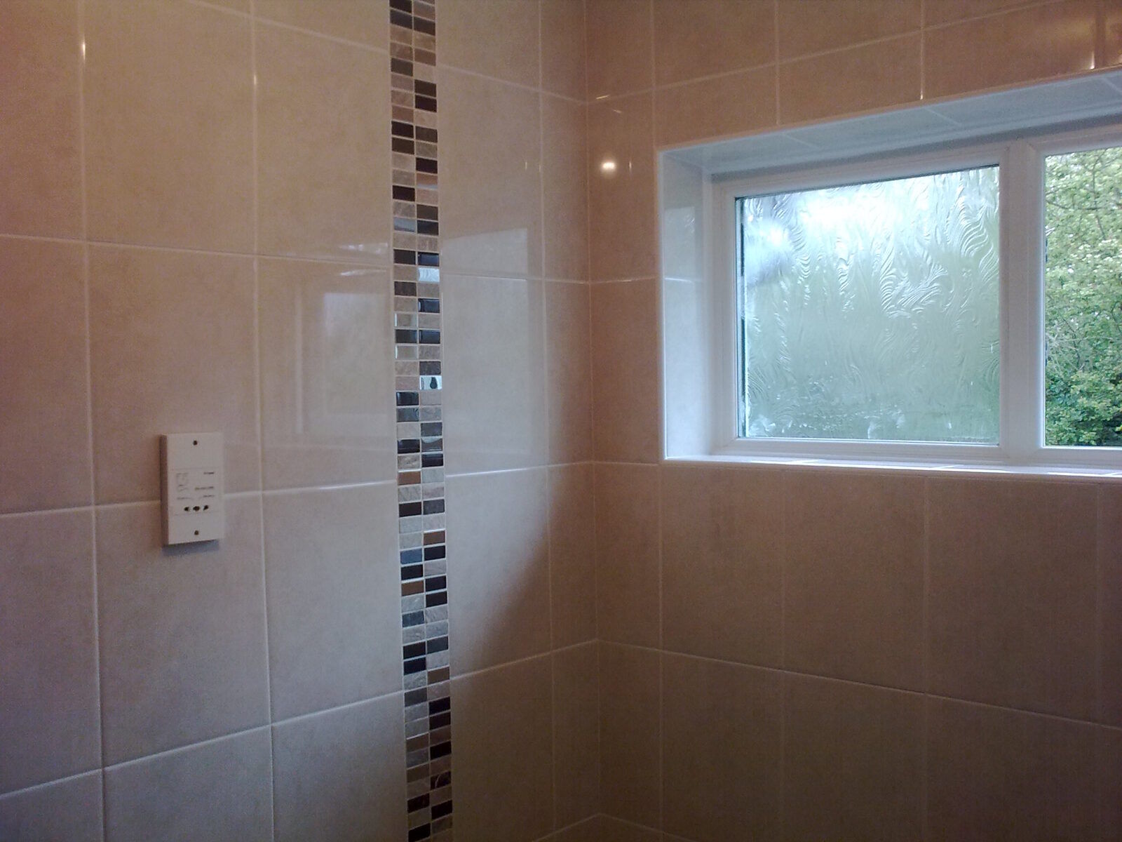 White tiled bathroom wall