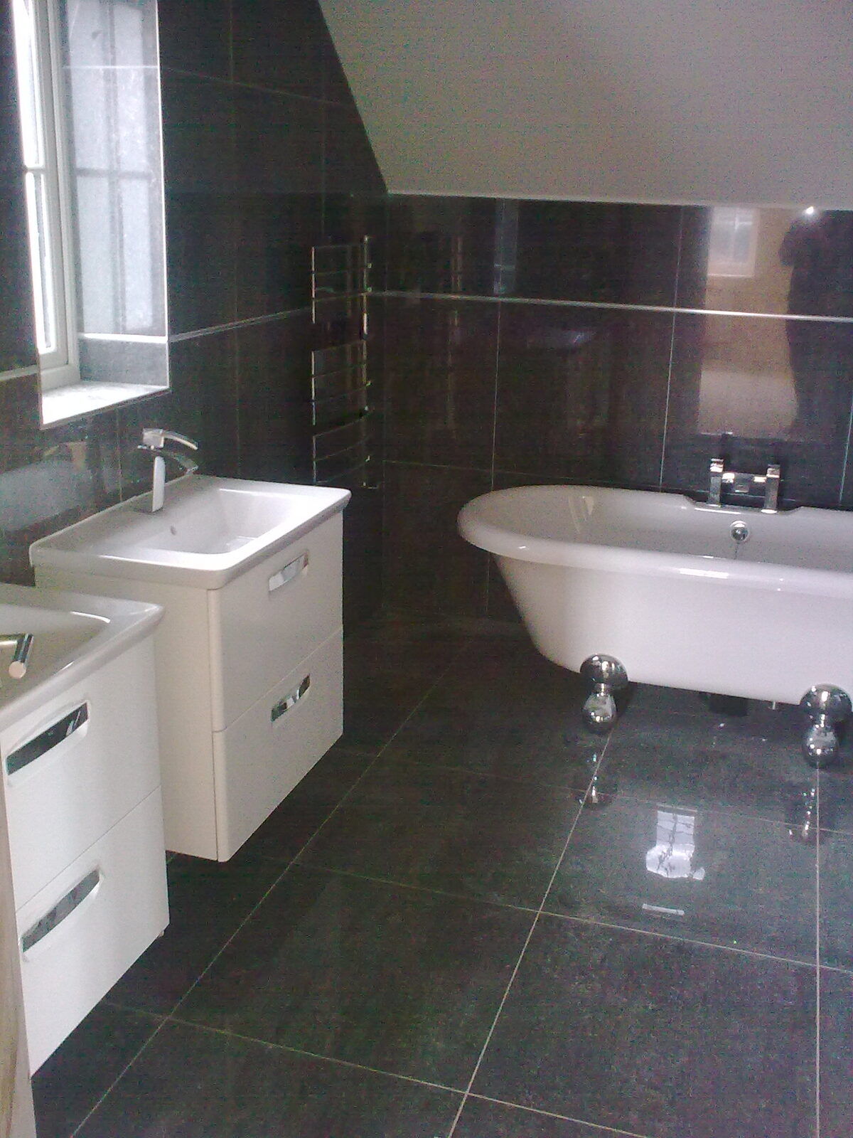 Fully tiled bathroom with modern vanity unit by G Perks Tiling