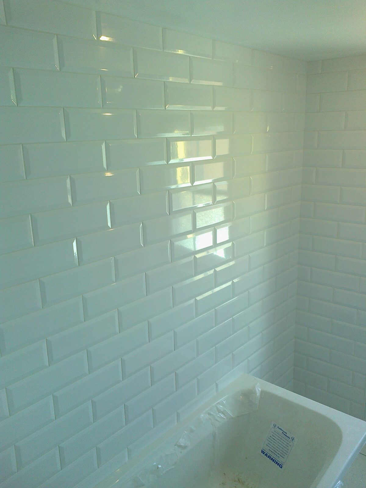 Glass tiled bath surround